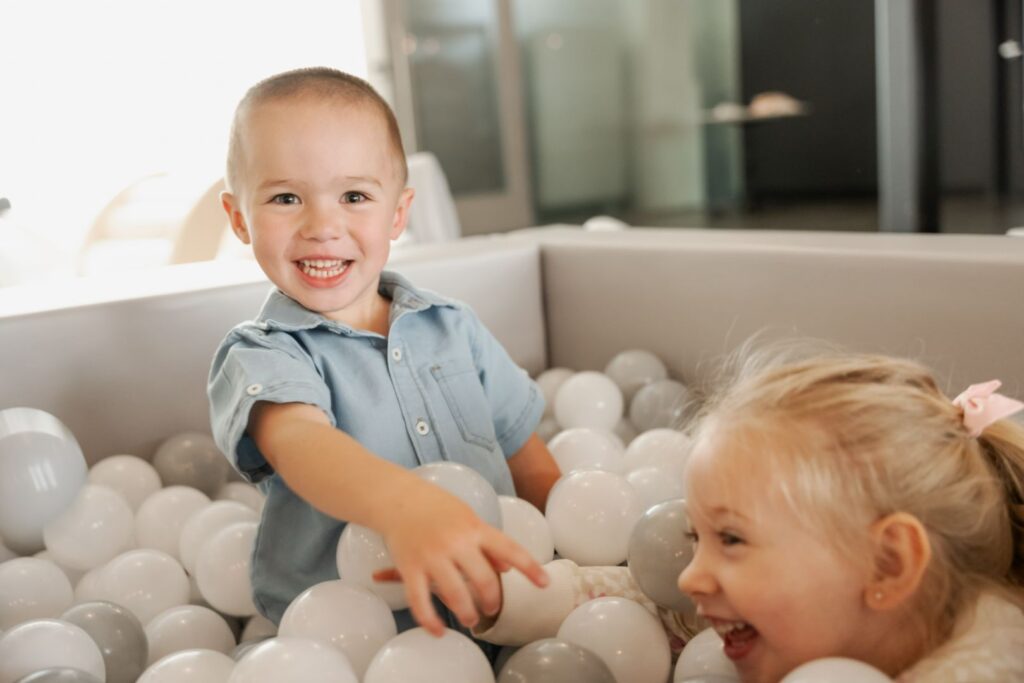 kids playing happy in a ball pit